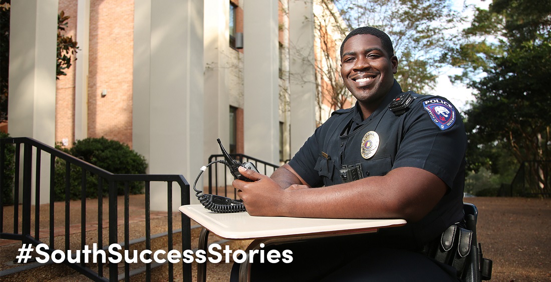 University of South Alabama Police Officer Roy Mendenhall, sitting in front of the Humanities Building where he once took classes, earned a degree in criminal justice in 2016. He's one of three officers at South who graduated from the University that same year.