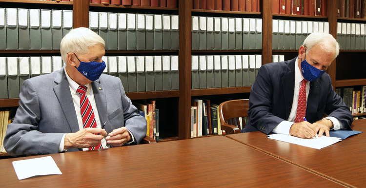 U.S. Rep. Bradley Byrne signs the Deed of Gift as Dr. Tony Waldrop, president of the University of South Alabama, looks on. The University now houses the congressional records of four Alabama District 1 representatives spanning 56 years.