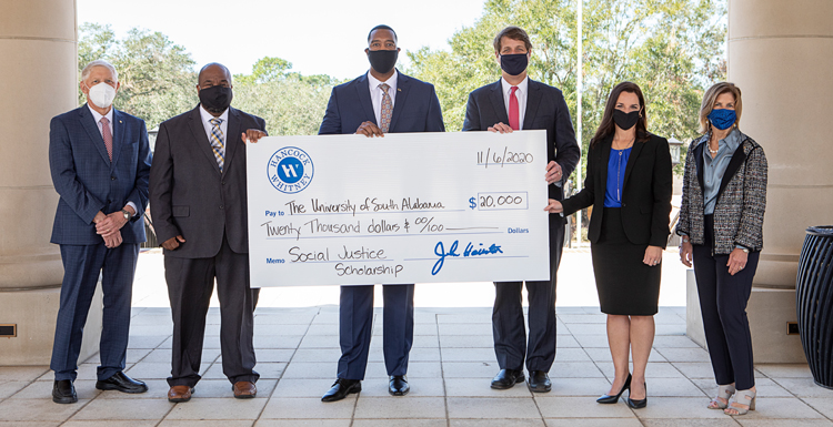 From left, University of South Alabama President Dr. Tony Waldrop, Associate Vice President of Academic Affairs and 100 Black Men of Greater Mobile President Dr. André Green, Hancock Whitney Business Banker Tramaine Perry, Alabama Market President Guy Helmsing, Middle Market Banker Angela Dunn, and USA Vice President for Development Margaret Sullivan at Moulton Tower and Alumni Plaza. 