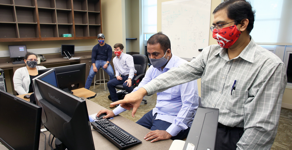From left, University of South Alabama students Crystal Pitts, Josh Yang, Aaron Mattox, Muhammed Mubasshir Hossain and Associate Professor Dr. Saeed Latif meet to discuss the SWARM-EX project that will lead to small satellites launched into the atmosphere. data-lightbox='featured'