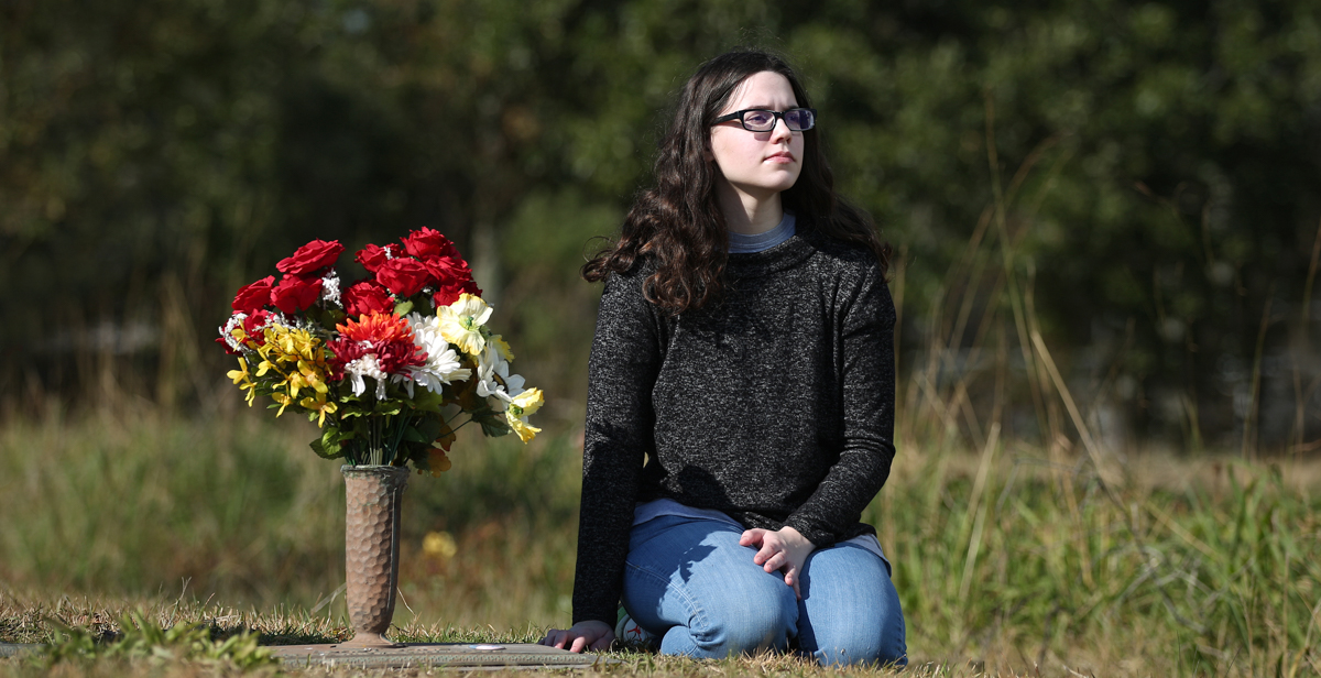 Olivia McCarter still visits the grave at Jackson County Memorial Park of Alisha Ann Heinrich after helping identify her using DNA samples and genealogy records. Next to the plot is the grave of another baby girl whose body has never been identified.