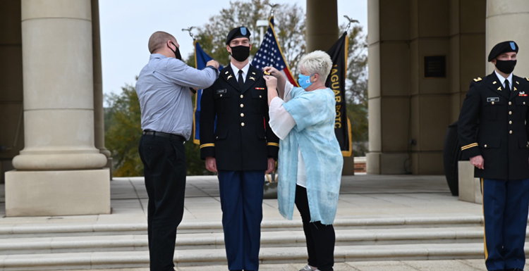 USA student 2nd Lt. Zachary LaJoie, a recent graduate, received his military commission after completing the USA Army ROTC program last fall. LaJoie’s parents Steve and Bonnie pin his bars onto the uniform during the ceremony.