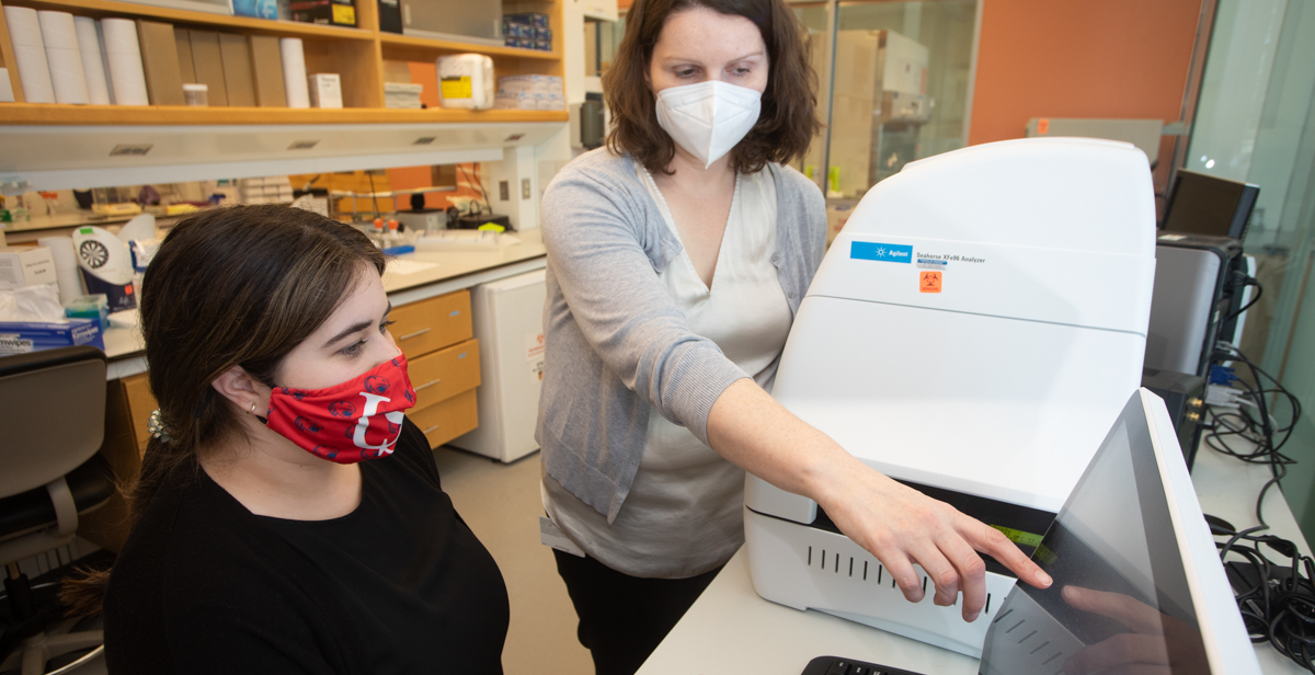 Dr. Natalie Gassman, an assistant professor of physiology and cell biology at the University of South Alabama, and graduate student Arlet Hernandez left, are conducting experiments and continuing research on the harmful effects of dihydroxyacetone, a molecule produced by electronic cigarettes, at the USA Health Mitchell Cancer Institute. data-lightbox='featured'