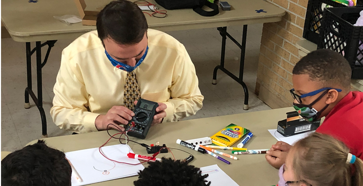 While volunteering, Dr. Martin Frank, assistant professor of physics at South Alabama shares the importance of activities that incorporate Science, Technology, Engineering, Art and Math with local elementary school students. data-lightbox='featured'