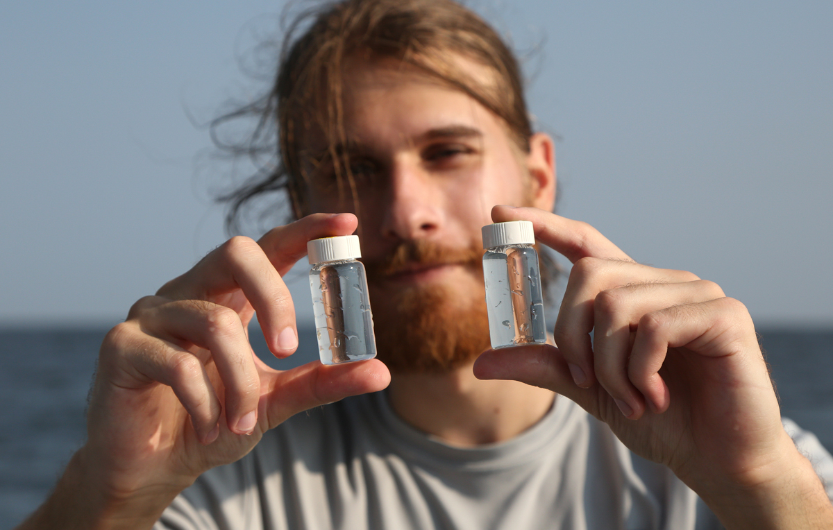 Graduate student Chris Mikolaitis holds water samples collected from Mobile Bay. “No matter where you go in marine science, you’re always looking at a profile of temperature, salinity, pH and oxygen,” he said. 