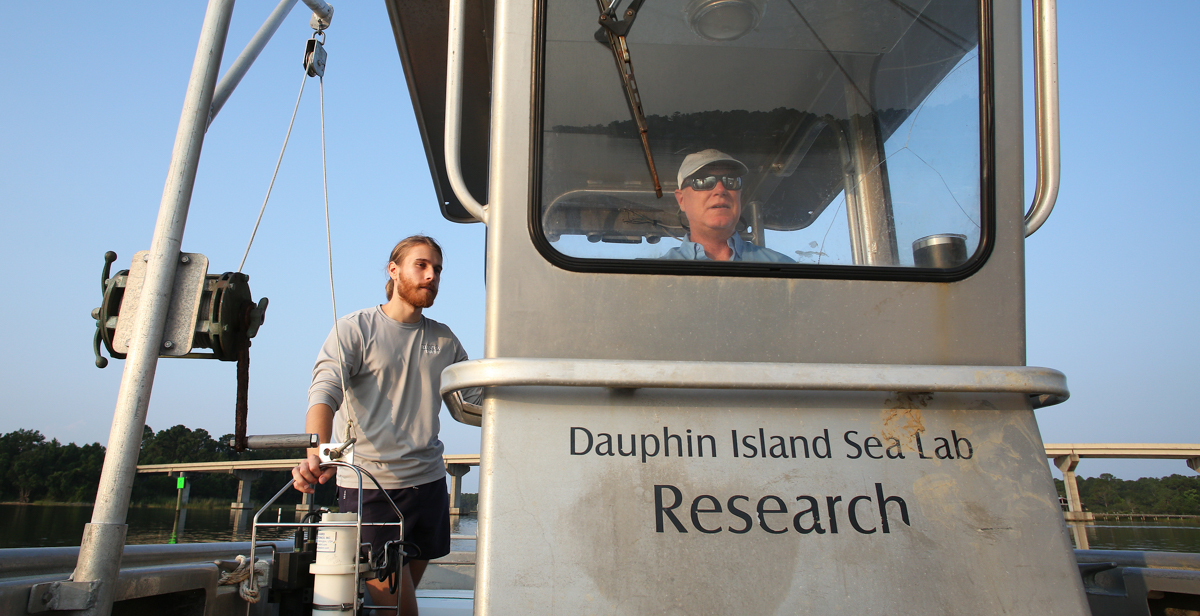 Dr. John Lehrter, associate professor of marine science, pilots a boat through Mobile Bay, where he and graduate Chris Mikolaitis took water samples to measure the health of its marine ecosystem. 