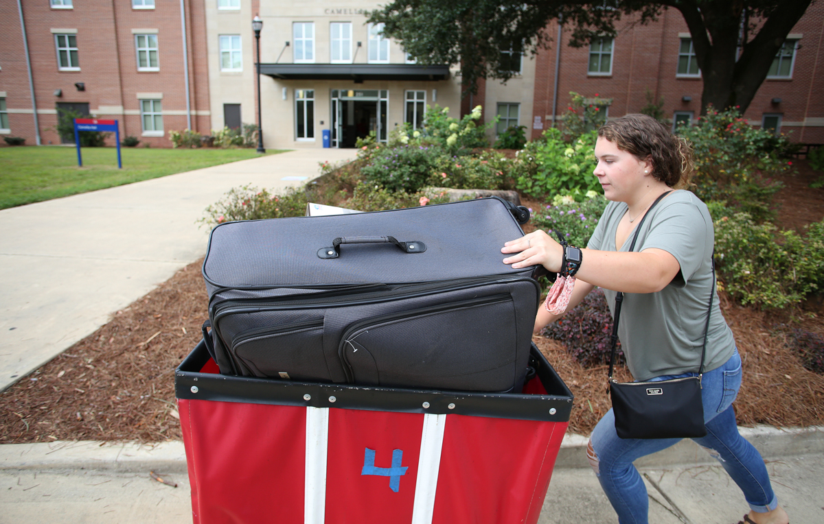 Patricia Brannan, a freshman from Hawaii, wheels her luggage to her new home on South’s campus. 