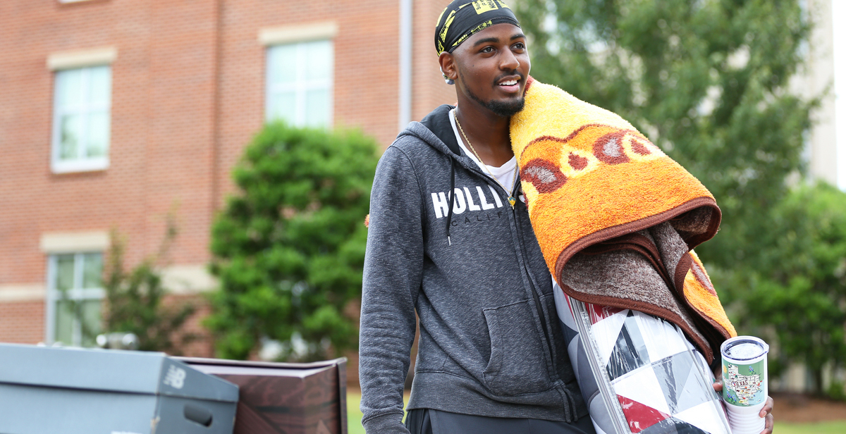 Jeffery Baity of Selma, Alabama, moves his belongings, including a blanket given to him by his aunt, into Camellia Hall at the University of South Alabama. Students are arriving on campus for fall semester before classes begin Tuesday. data-lightbox='featured'
