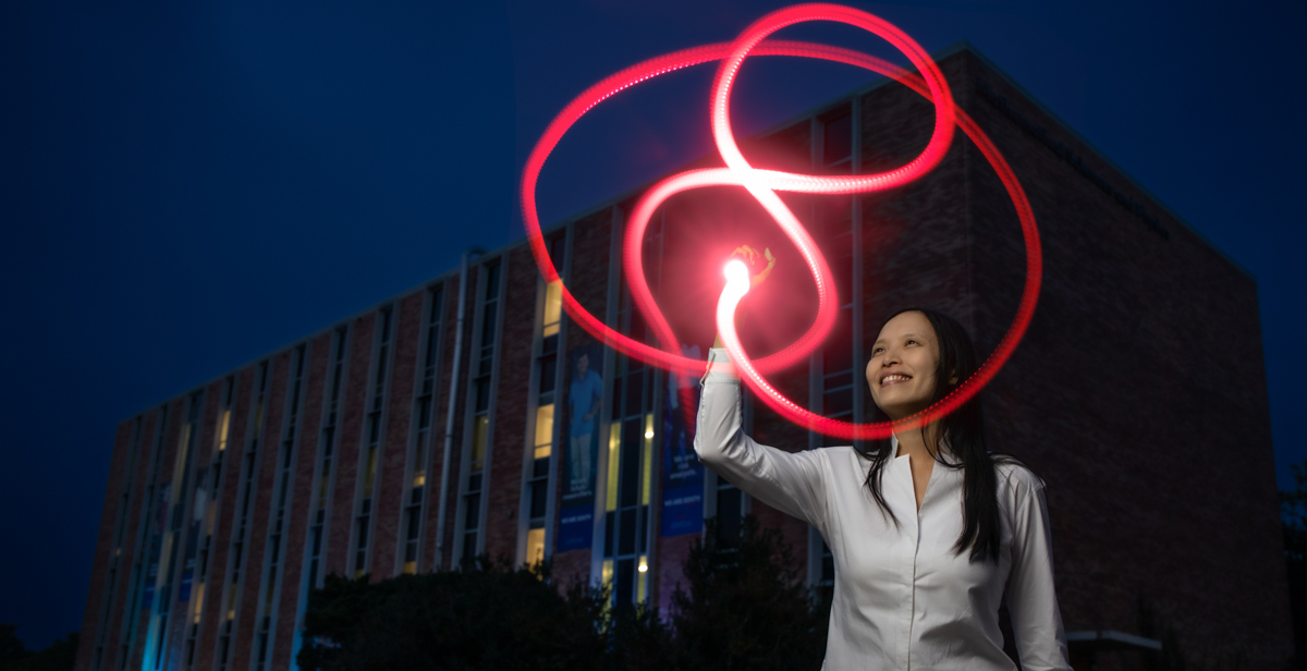 Dr. Christine Ruey Shan Lee traces a figure-eight knot with light outside the Mathematical Sciences and Physics Building at the University of South Alabama. Her research in quantum topology earned a grant from the National Science Foundation.  