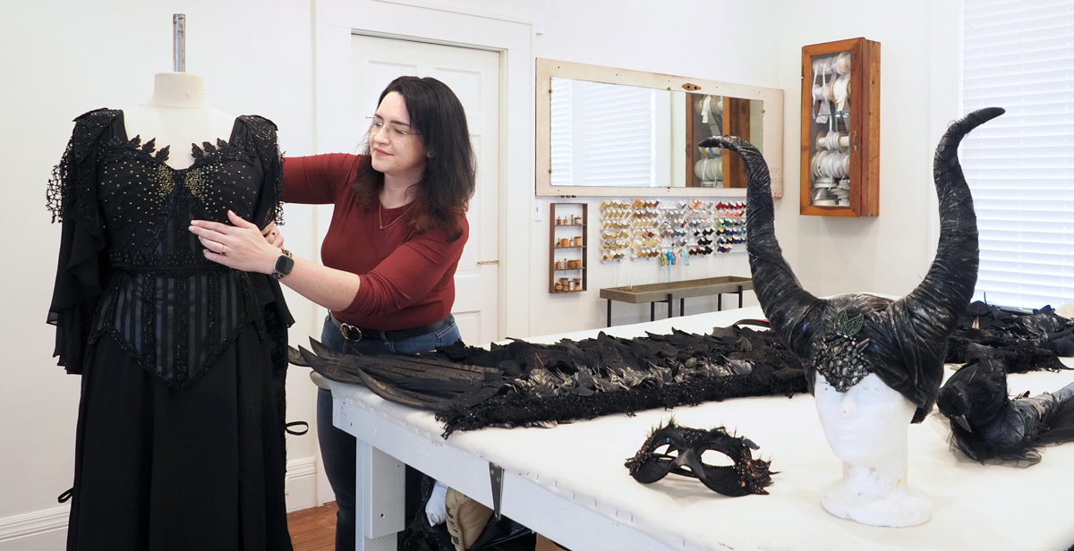 Christina Johnson, who teaches drama and costume design at South, works on a Mardi Gras gown at the Revelry Bloom studio in Mobile. The elaborate costume,  inspired by the movie “Maleficent,” has been chosen for display at the Mobile Carnival Museum. data-lightbox='featured'