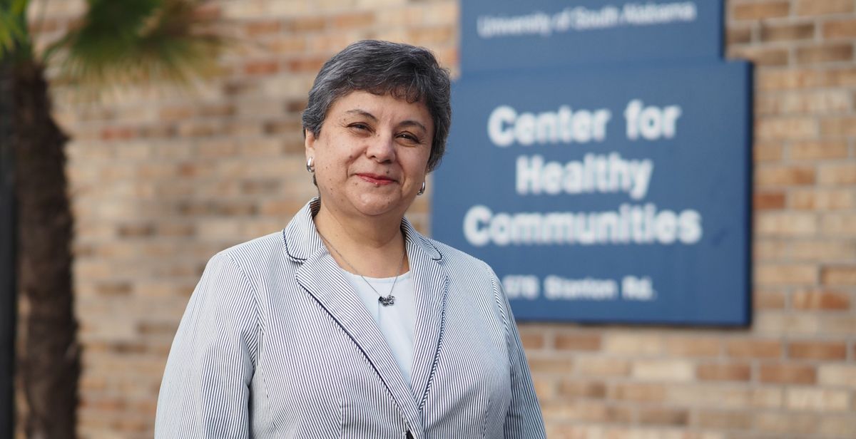 Dr.  Martha Arrieta, director of research for the USA Center for Healthy Communities, stands at the front of the center.  data-lightbox='featured'