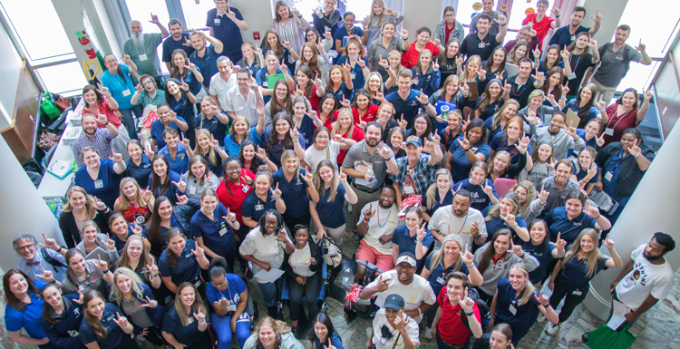 University of South Alabama faculty and staff from Pat Capps Covey College of Allied Health Professions, the department of psychology in the College of Arts and Sciences and the Alabama Head Injury Foundation pose with eleven survivors and caregivers at the 2022 Bright Ideas Traumatic Brain Injury Camp. South students and faculty served on a multidisciplinary team to help survivors with counseling, speech-language pathology, physical therapy, occupational therapy, cooking/nutrition sessions and assessments during a three-day camp.