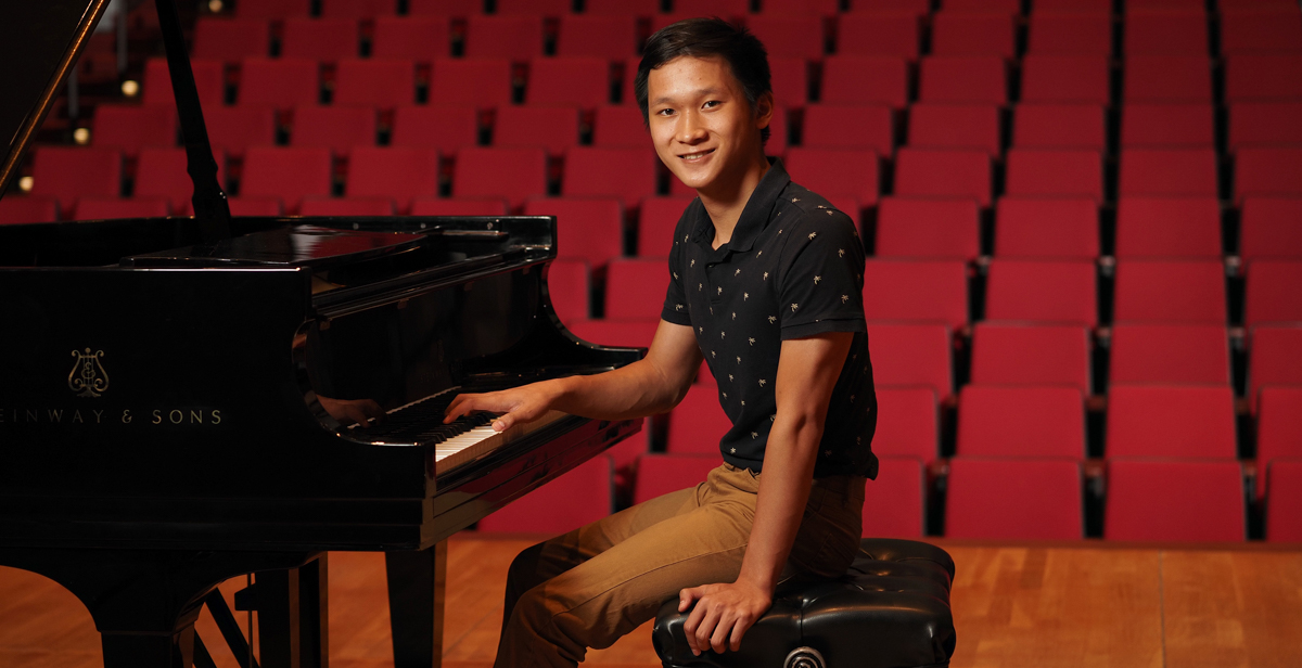 University of South Alabama student Paul Nguyen at a piano at Laidlaw Performing Arts Center on campus.