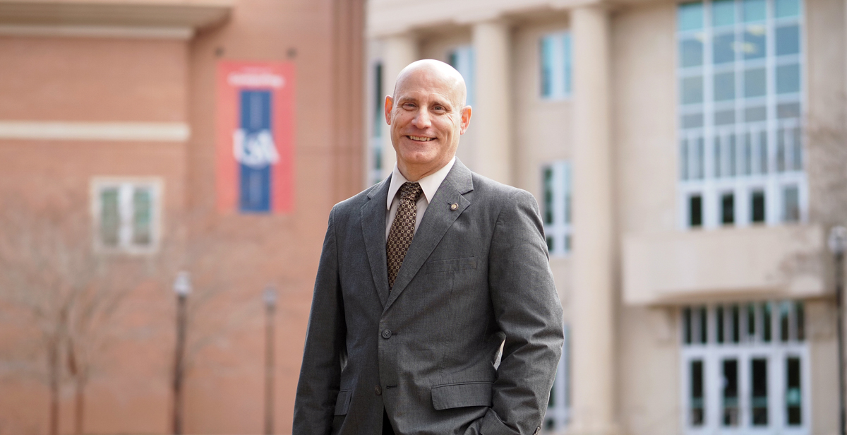 Dr. Todd R. Andel in front of the School of Computing at the University of South Alabama.  The school is designated as a National Center of Academic Excellence in Cyber Defense by the National Security Agency and the Department of Homeland Security.  data-lightbox='featured'