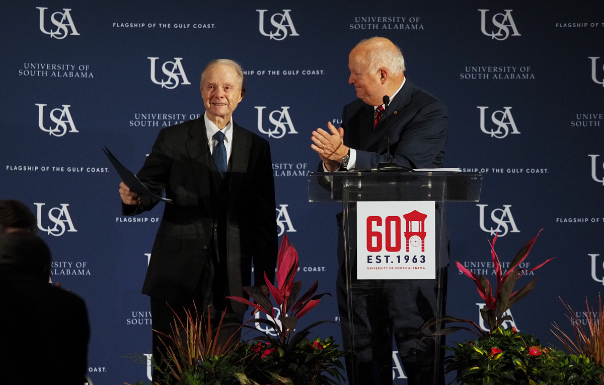 University of South Alabama President Jo Bonner, right, announces a $20 million gift from Abraham "Abe" Mitchell at the University's 60th Anniversary celebration. The donation will be used to build a new performing arts center on campus.  
