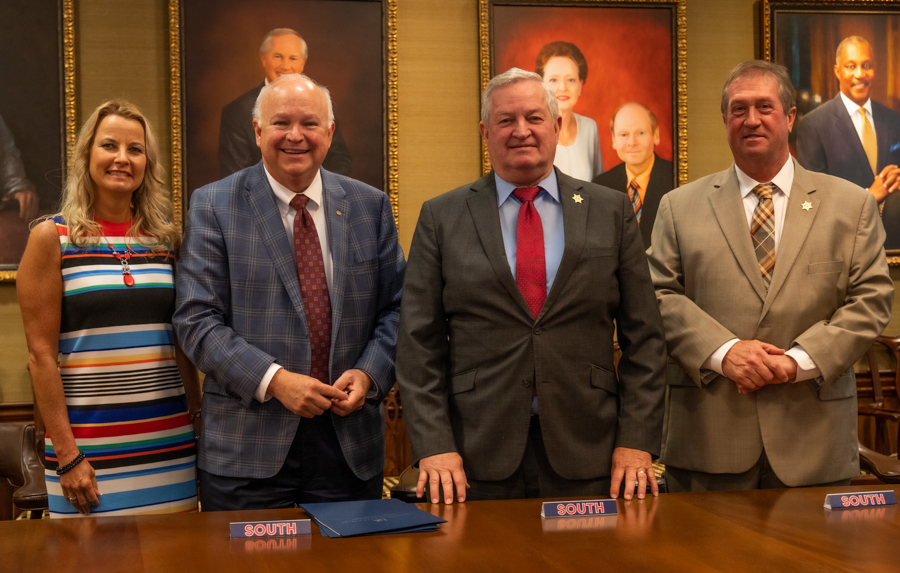 University of South Alabama Executive Vice President and Provost Dr. Andi Kent, from left, and President Jo Bonner, meet to sign an agreement with former Mobile County Sheriff Sam Cochran and Sheriff Paul Burch that will provide scholarships to Mobile County deputies and correctional officers seeking an undergraduate degree in criminal justice. 