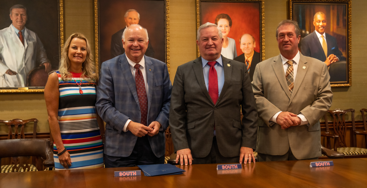 University of South Alabama Executive Vice President and Provost Dr. Andi Kent, from left, and President Jo Bonner, meet to sign an agreement with former Mobile County Sheriff Sam Cochran and Sheriff Paul Burch that will provide scholarships to Mobile County deputies and correctional officers seeking an undergraduate degree in criminal justice.  data-lightbox='featured'