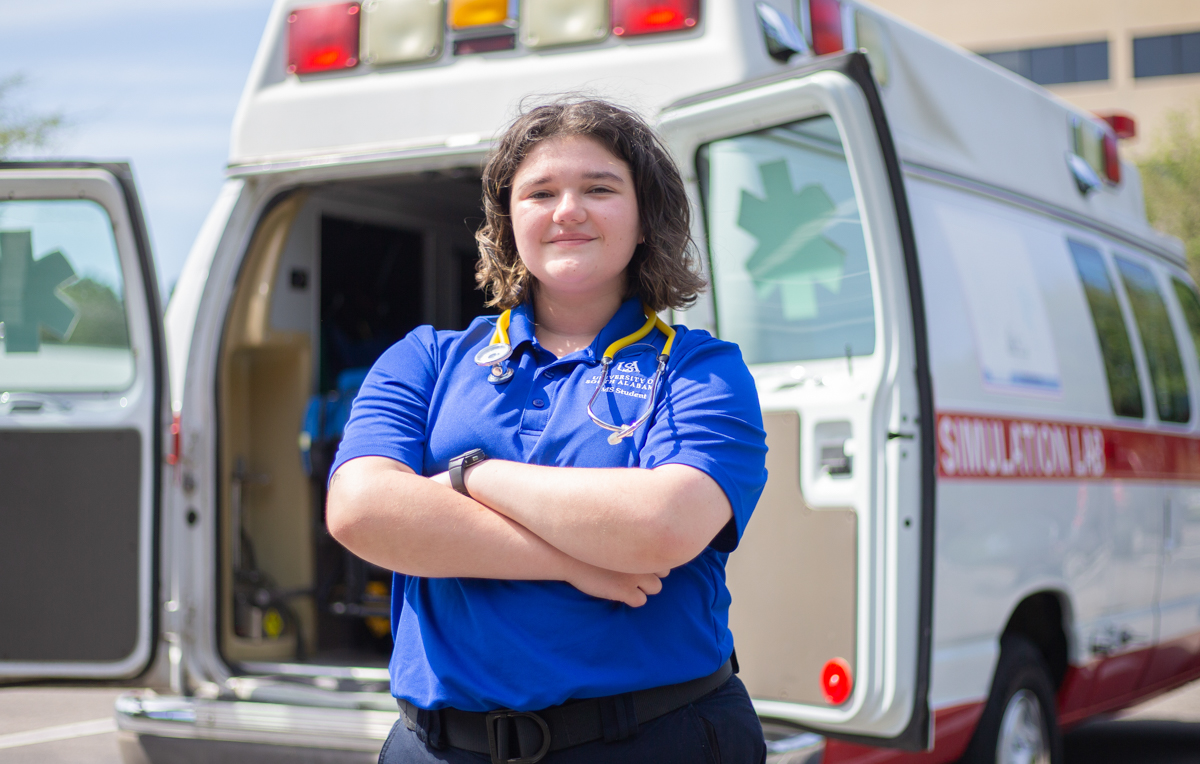 Chloé Knippers works part-time for a Mobile ambulance company. Here, she is in front of the University of South Alabama's Mobile Simulation Lab. 