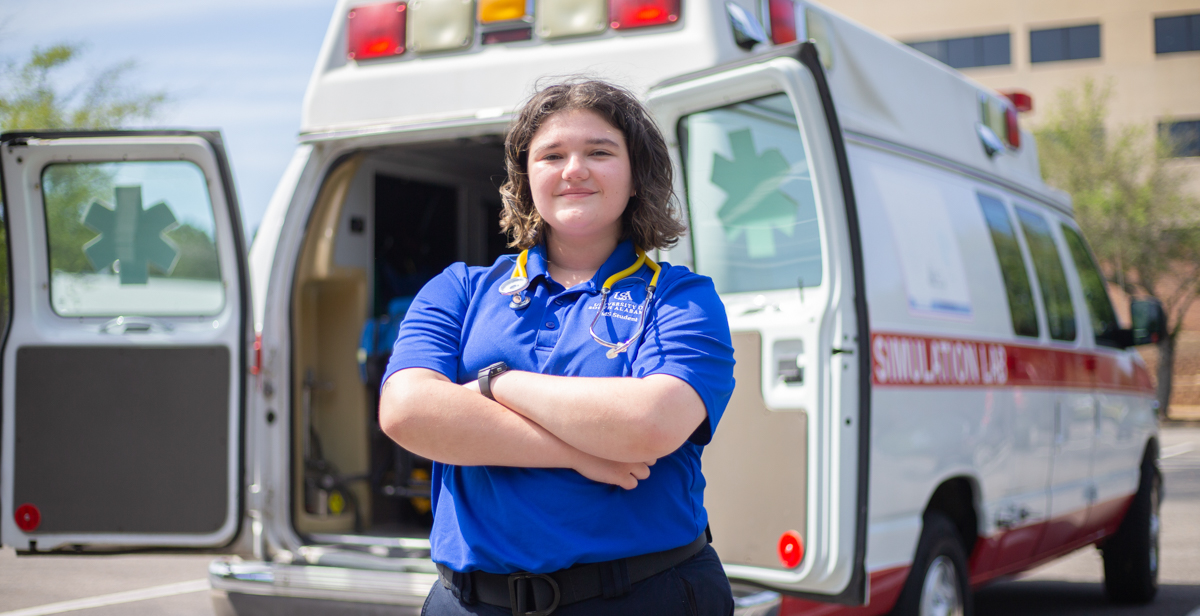 Chloé Knippers works part-time for a Mobile ambulance company. Here, she is in front of the University of South Alabama's Mobile Simulation Lab. 