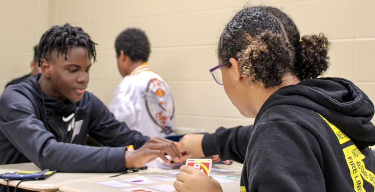 Galvin Morris and Kianna Blackman play the card game "Set" as part of the Math Corps summer program at the University of South Alabama.