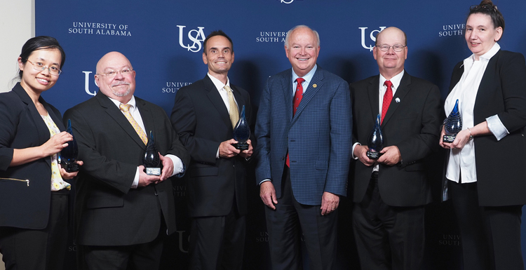 2nd annual USA Technology and Research Showcase honorees. Dr. Na Gong, professor of electrical and computer engineering; Dr. James Davis, professor of chemistry; Dr. Jordan Shropshire, professor of information systems and technology; USA President Jo Bonner; Dr. Sean Powers, professor of marine and environmental sciences and senior marine scientists at the Dauphin Island Sea Lab; Dr. Marie Migaud, professor of pharmacology and oncology. data-lightbox='featured'