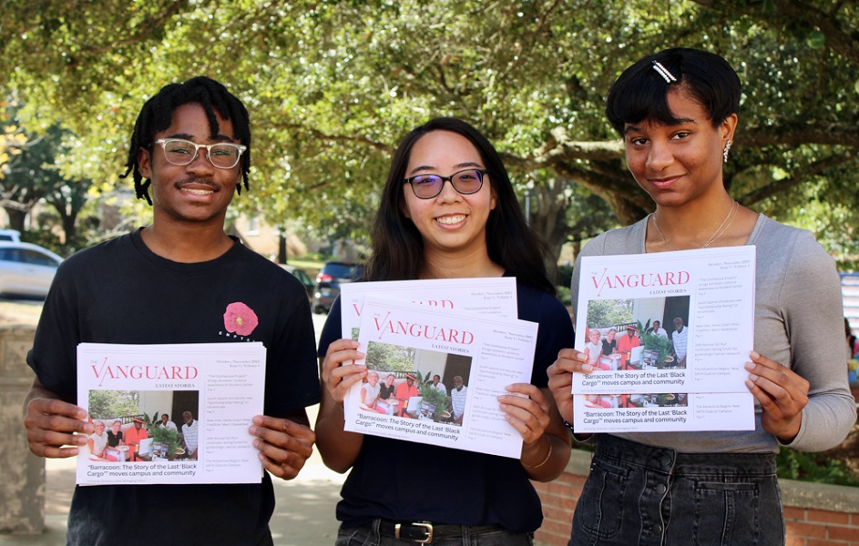 With print editions of The Vanguard student newspaper are, from left, Brandon Clark, managing editor; Stephanie Huynh, editor-in-chief; and Iman Thibodeaux, contributing writer.