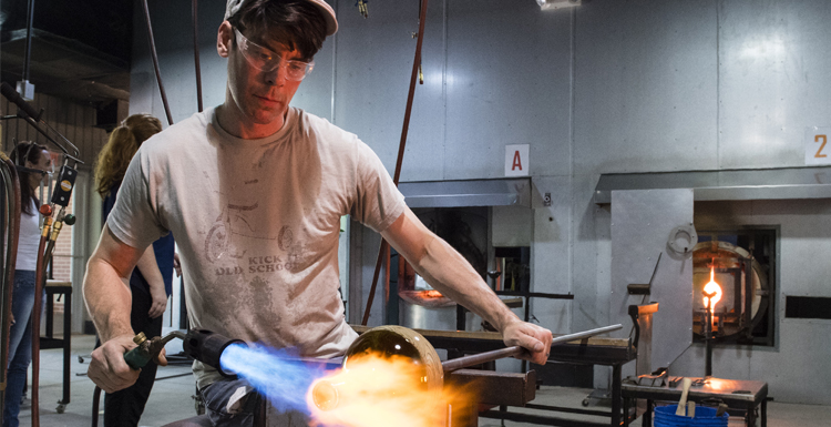 USA associate professor Matthew Patterson refines his glass art project.