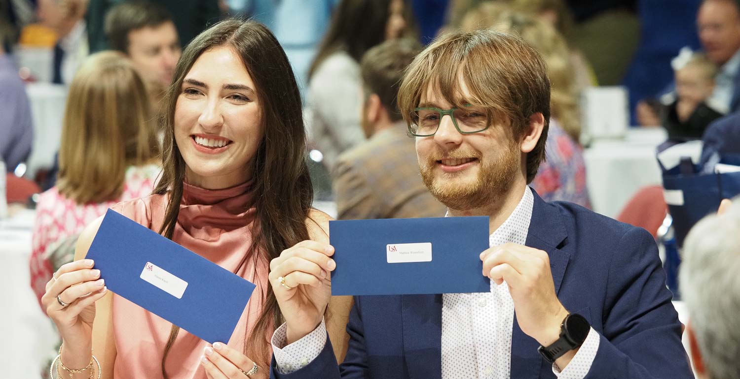 Medical students holding their Match Day envelopes