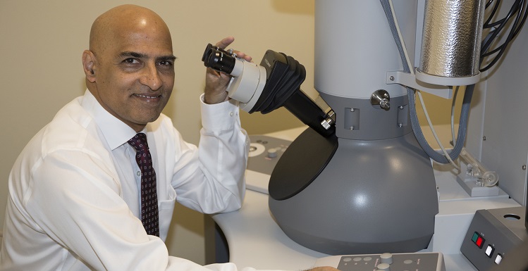 Dr. Srinivas Palanki, professor and chair of chemical and biomolecular engineering, with the University?s new Transmission Electron Microscope, which will allow researchers to examine structure, composition and properties of materials at a scale of a nanometer.