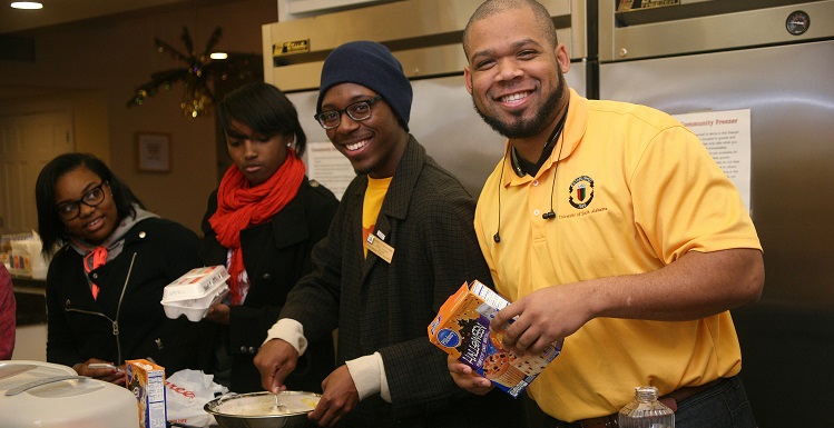 USA African American Student Association members teamed up to bake cakes and cupcakes and organize toys for ill and injured children and their families at Ronald McDonald House. AASA President DeWitt Ford, marketing major, far right, vounteers with Service Chair Carl Thomas, marketing major, and other members of AASA.