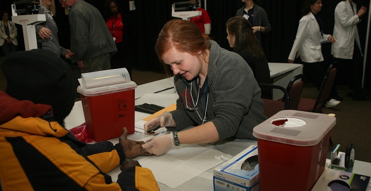 USA nursing student Sydney Spradlin provides health screenings and education at Project Homeless Connect 2016 held on Jan. 28, at the Mobile Greater Gulf State Fair Grounds.  data-lightbox='featured'