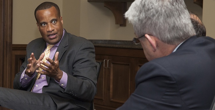 U.S. Assistant Secretary of Commerce Jay Williams, left, talks with USA Mitchell College of Business Dean Dr. Bob Wood and other administrators during a recent visit to campus. 