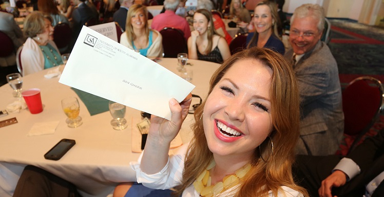 Sara Gonzales holds her envelope as she waits for the ringing of the bell signaling medical school students can find out where they matched during the University of South Alabama College of Medicine's Match Day event March 20, 2015, at the Arthur R. Outlaw Mobile Convention Center.