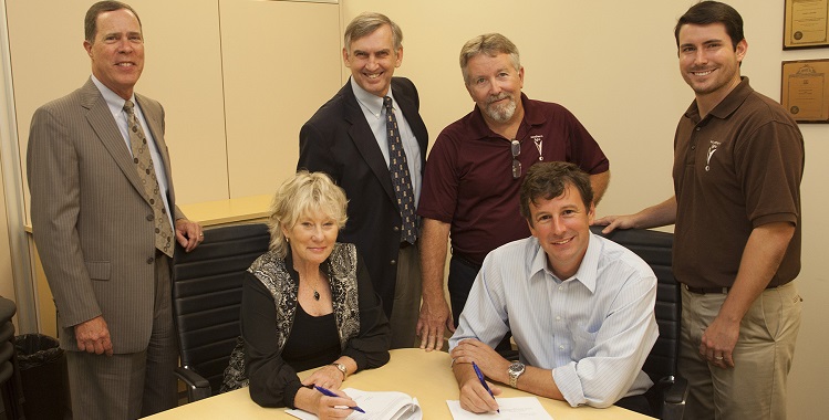 Southern Light is expanding its presence at USA Technology and Research Park. At a lease signing, from left, are Ken Davis, USA treasurer; Lynne Chronister, USA vice president for research and economic development; Ker Ferguson, USA assistant vice president for research; Roy Franklin, Southern Light data center operations manager; Andy Newton, Southern Light president and CEO; and Davis Pilot, Southern Light operations strategic analyst.  