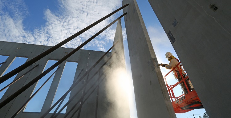 A construction worker is shown on site at the USA Physicians Group Professional Office Building. 