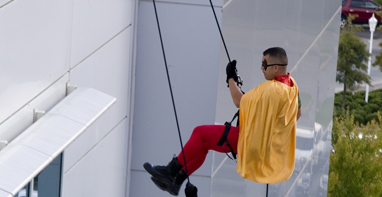 Superheroes from the Mobile Police Department's SWAT team and a few Mobile Fire-Rescue firefighters rappelled down the side of USA Children's & Women's Hospital to help nine children celebrate the end of their cancer treatment.