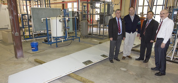 The donation of an A330 elevator from Airbus to the University of South Alabama will make "possible for our engineering students to study and test a very large commercial version of the high-strength materials that are the subject of their classes and laboratory experiments," said Dr. John Steadman, dean of the College of Engineering. Standing with the elevator, from left, are Steadman; David Trent, Airbus Mobile Engineering Center site director; Dr. Kuang-Ting Hsiao, USA mechanical engineering professor; and David Nelson, chair of mechanical engineering. 