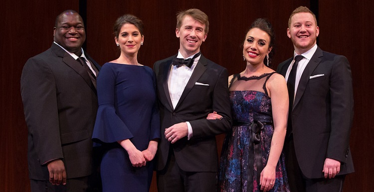 Nicholas ?Nick? Brownlee, far right, joins fellow finalists on the stage of the Metropolitan Opera in New York shortly after he was announced as a winner on Sunday of the prestigious Metropolitan Opera National Council Auditions. Brownlee, a 2012 graduate of USA in vocal performance, is considered one of the rising stars of the opera world.