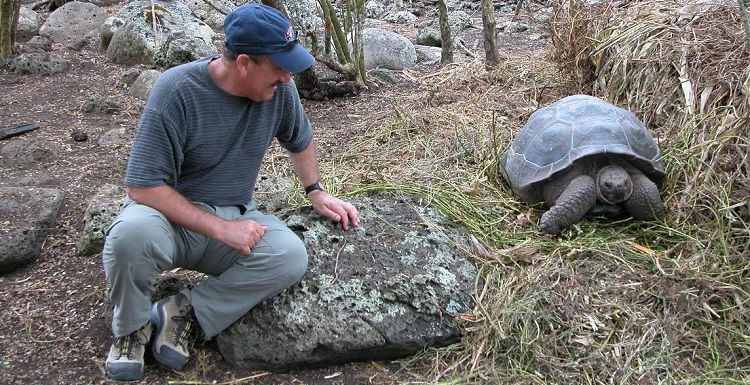 Dr. Stephen J. Walsh watches a Galapagos Island turtle during a visit to the Galapagos Science Center. Walsh is recognized internationally for his studies of human impacts on the islands. 