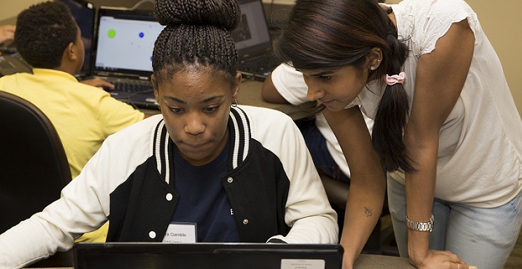 Attendees at the 2015 GenCyber Camp held at USA's School of Computing look over the day's assigned task. The camp is sponsored by the National Security Agency and the National Science Foundation. About 30 students and several teachers from Davidson High School are participating.