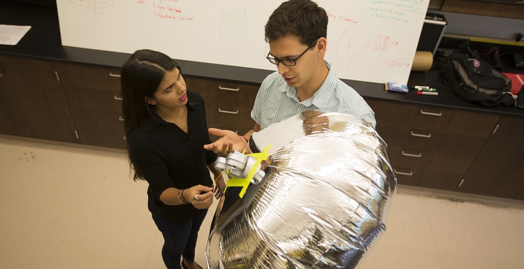 Brandi DePineuil, left, a junior mechanical engineering major from Ocean Springs, Miss., works with Dr. Carlos Montalvo, assistant professor of mechanical engineering, on blimp dynamics where she learned to do mathematics modeling and write code. 