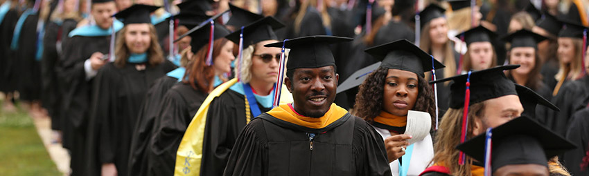Student walking across stage for graduation