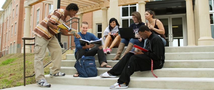 Students sitting outside of their residence hall