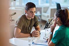 Male talking to female at desk