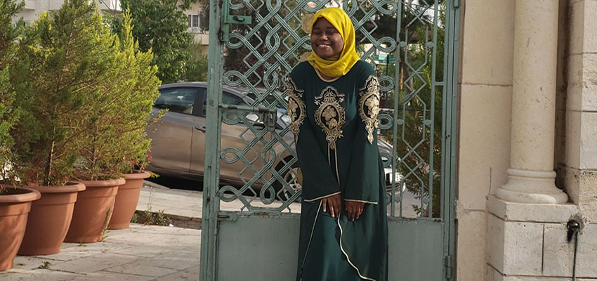 Abdul in front of a building