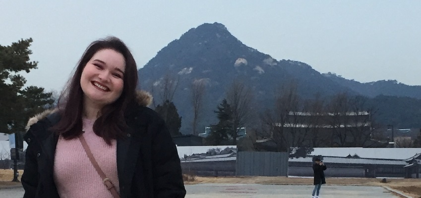 Andie in front of a mountain in South Korea