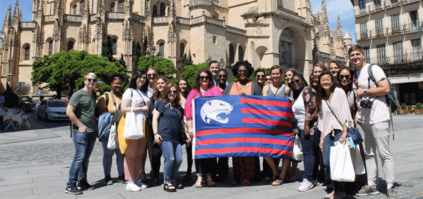 Auriel Moore in Spain with group carrying USA flag.