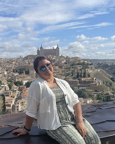 Woman Sitting with Pretty Architecture