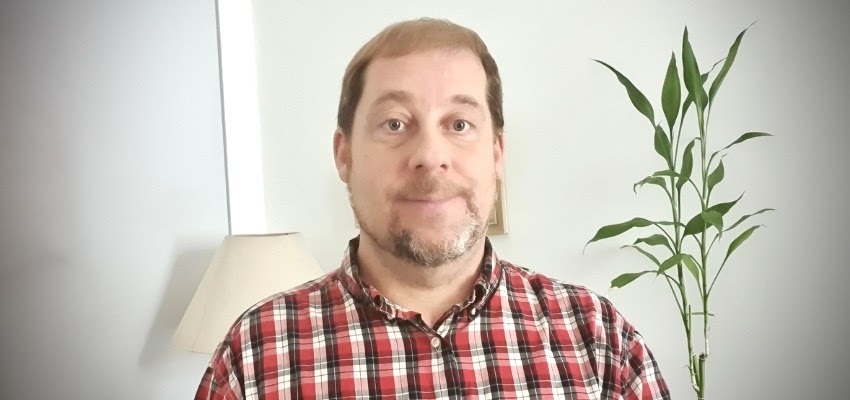Jason Winters in front of wall background. data-lightbox='featured'