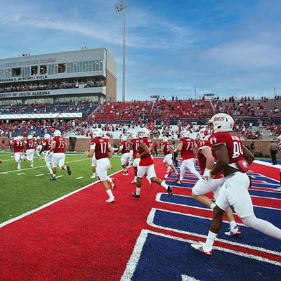 USA Football players running on the field.